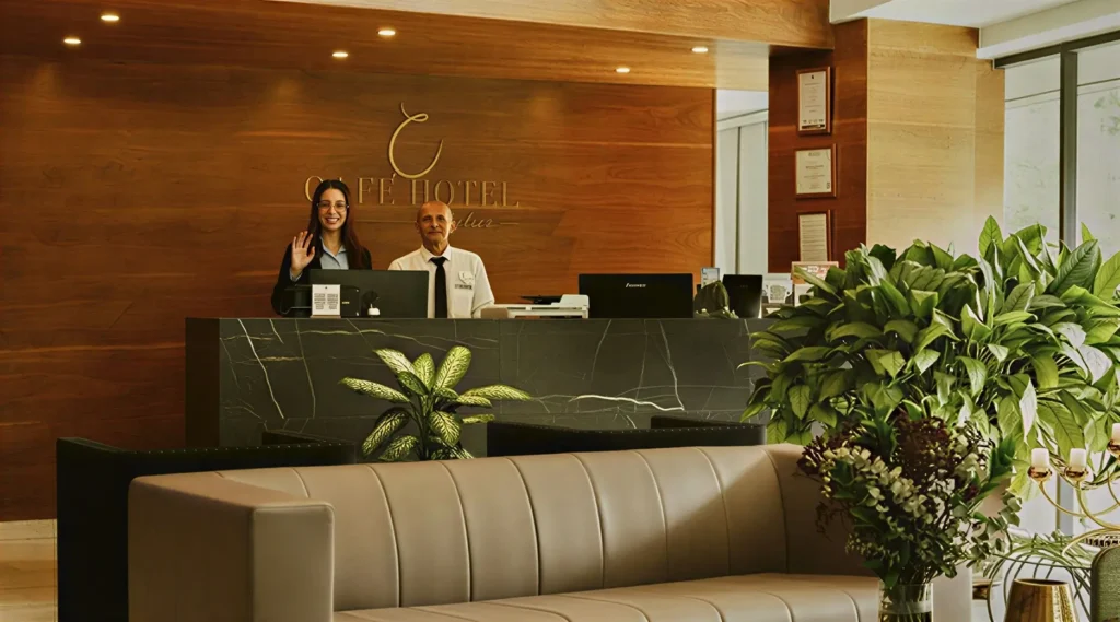 Front desk staff welcoming guests at Café Hotel in El Poblado Medellín.